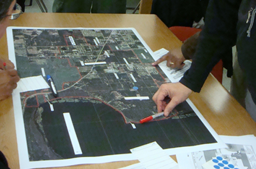 A photo of planning staff pointing on a map