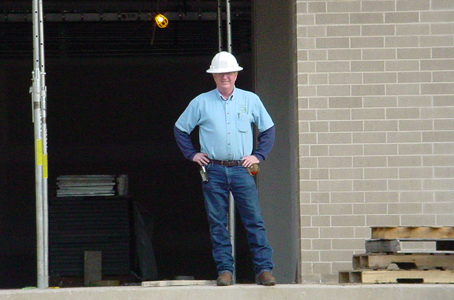 A photo of an inspector standing in front of a building