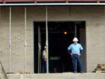 A photo of an inspector standing in front of a building