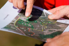 A photo of people pointing at a map