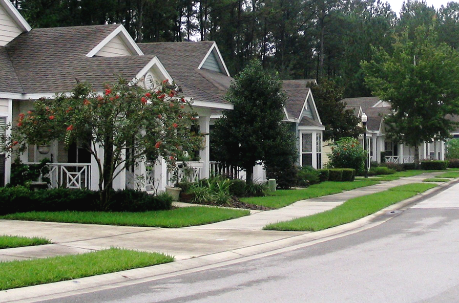 A photo of a street with residential houses